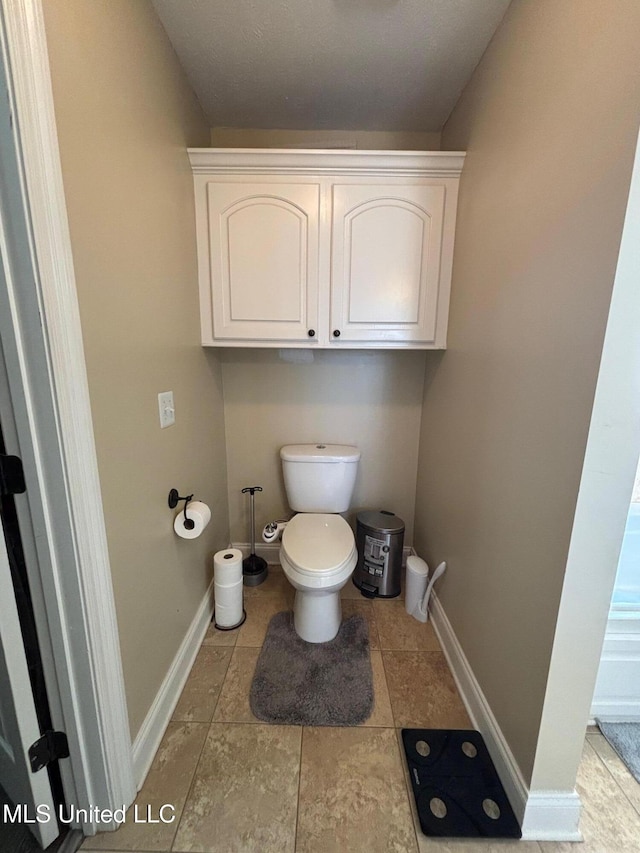 bathroom with tile patterned flooring and toilet