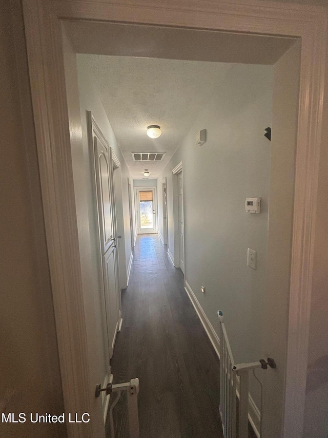 hallway with dark wood-type flooring