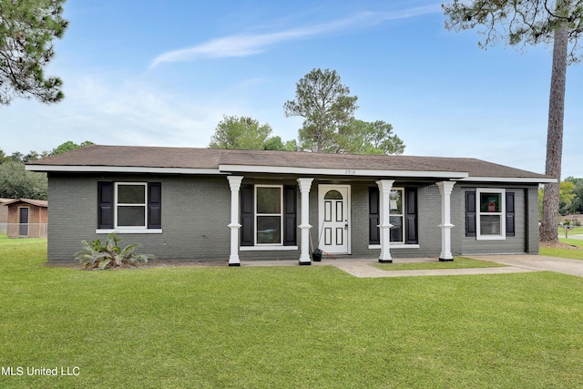 ranch-style home featuring brick siding, a porch, and a front lawn