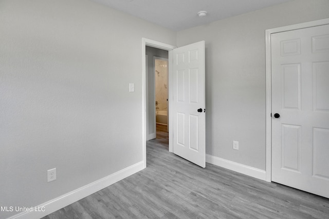 unfurnished bedroom featuring light wood-type flooring