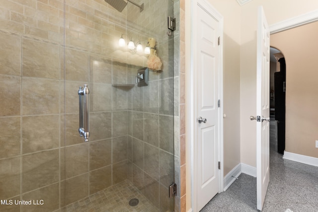 bathroom with a shower with door