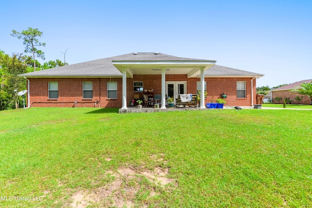 rear view of house featuring a yard and a patio area