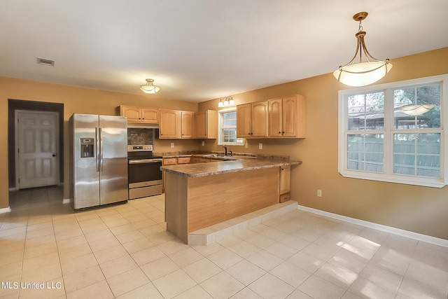 kitchen with light brown cabinets, hanging light fixtures, kitchen peninsula, sink, and appliances with stainless steel finishes