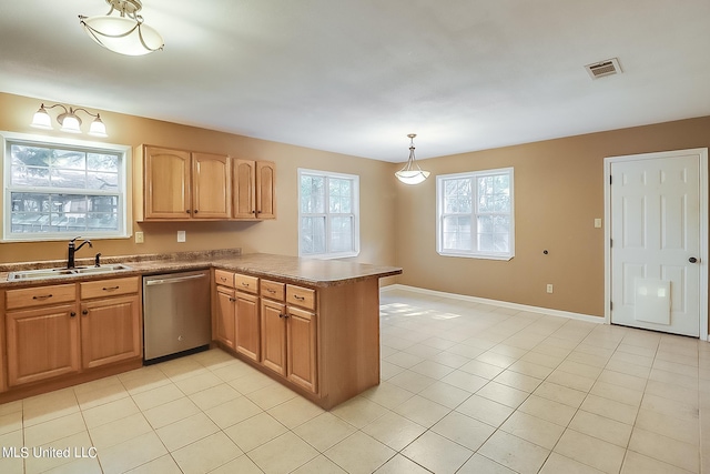 kitchen featuring dishwasher, kitchen peninsula, sink, decorative light fixtures, and light tile patterned floors