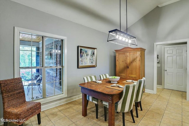 tiled dining area with vaulted ceiling