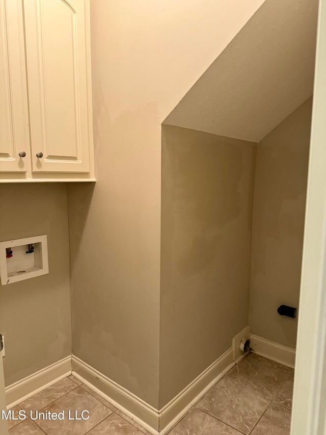 laundry area featuring hookup for an electric dryer, washer hookup, light tile patterned floors, and cabinets