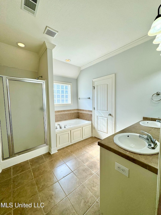 bathroom featuring separate shower and tub, a textured ceiling, ornamental molding, and tile patterned floors