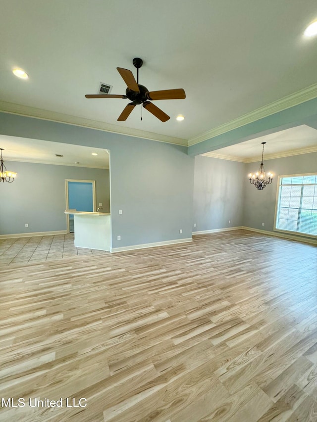 unfurnished room with light hardwood / wood-style flooring, ornamental molding, and ceiling fan with notable chandelier