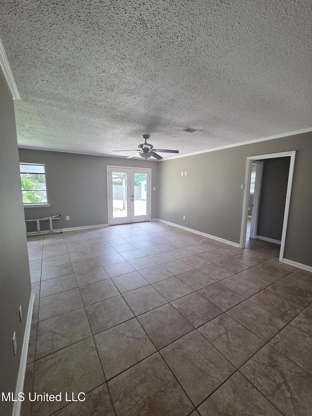 1442 Tally Ho Cir, Gulfport, MS 39507 - empty room featuring tile patterned floors, healthy amount of natural light, french doors, ceiling fan, and a textured ceiling