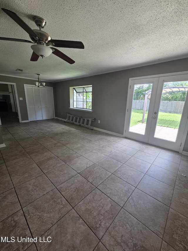 1442 Tally Ho Cir, Gulfport, MS 39507 - unfurnished living room with french doors, a textured ceiling, tile patterned flooring, and ceiling fan
