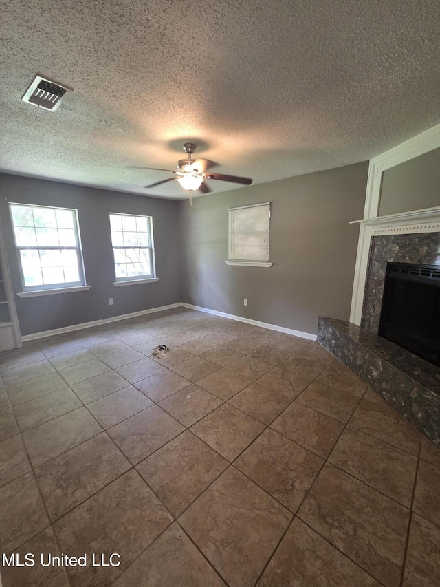1442 Tally Ho Cir, Gulfport, MS 39507 - tiled empty room featuring ceiling fan, a premium fireplace, and a textured ceiling