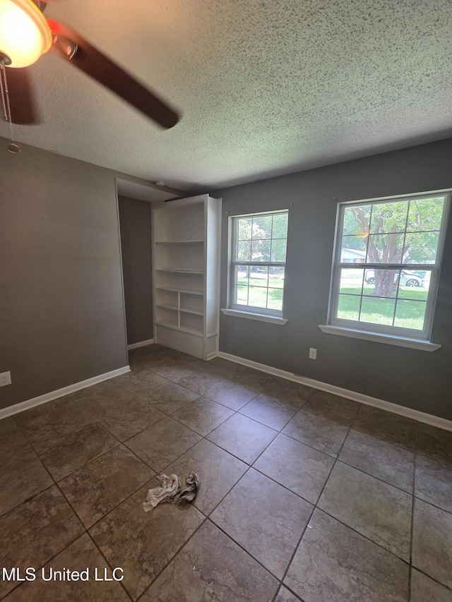 1442 Tally Ho Cir, Gulfport, MS 39507 - tiled spare room featuring a textured ceiling