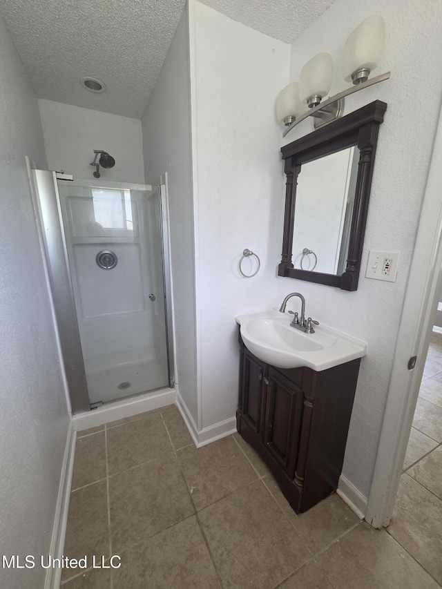 1442 Tally Ho Cir, Gulfport, MS 39507 - full bathroom with a textured ceiling, vanity, a stall shower, and tile patterned floors