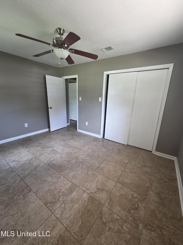 1442 Tally Ho Cir, Gulfport, MS 39507 - unfurnished bedroom with a textured ceiling, a closet, and a ceiling fan