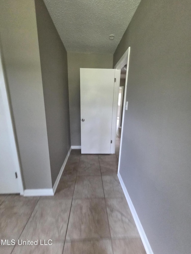 1442 Tally Ho Cir, Gulfport, MS 39507 - hall with a textured ceiling and baseboards