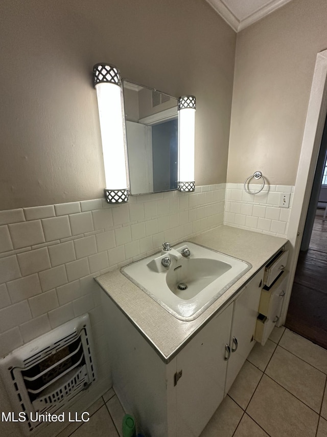 bathroom with tile walls, tile patterned floors, heating unit, and vanity