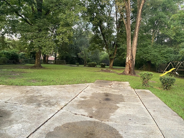 view of yard featuring a patio area and a playground
