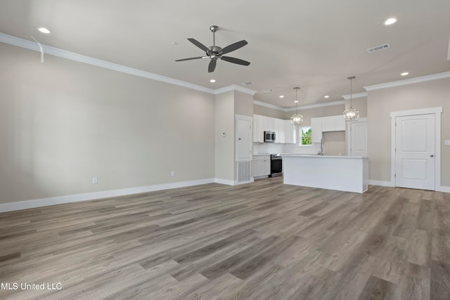 unfurnished living room with crown molding, ceiling fan with notable chandelier, and light hardwood / wood-style floors