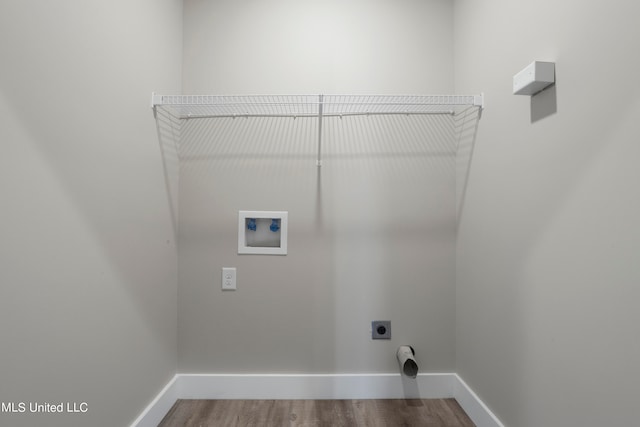 clothes washing area with hardwood / wood-style flooring, washer hookup, and electric dryer hookup