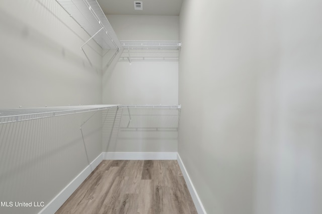 spacious closet featuring light wood-type flooring