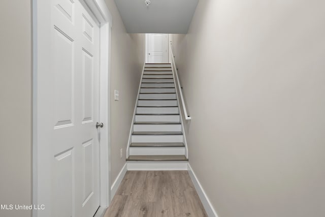 stairway featuring wood-type flooring