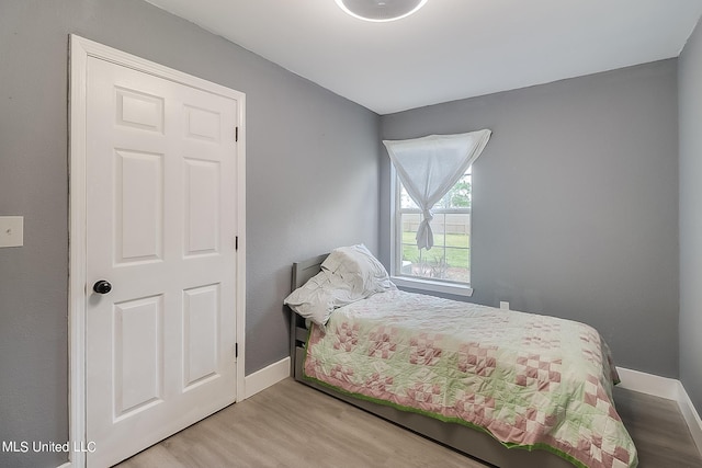 bedroom with hardwood / wood-style floors