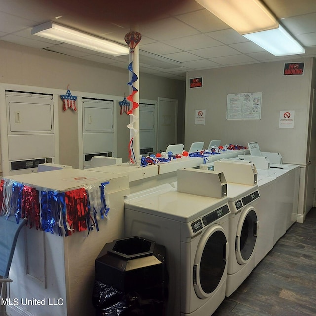 clothes washing area featuring washing machine and dryer, stacked washer / drying machine, and dark hardwood / wood-style floors