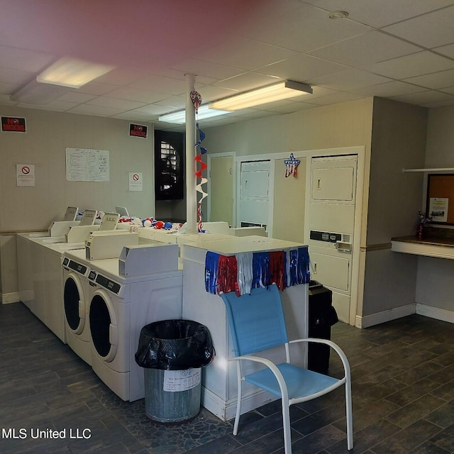 laundry area with washing machine and dryer, dark hardwood / wood-style flooring, and stacked washer and clothes dryer