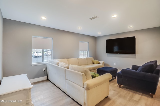 living room with light hardwood / wood-style floors and plenty of natural light