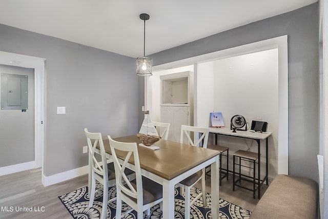 dining room with electric panel and hardwood / wood-style flooring