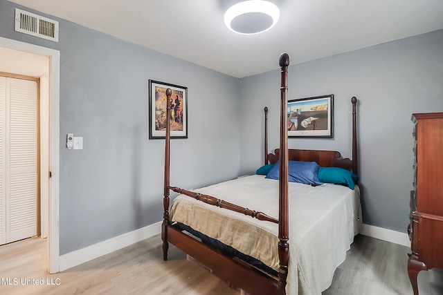 bedroom with a closet and light hardwood / wood-style flooring