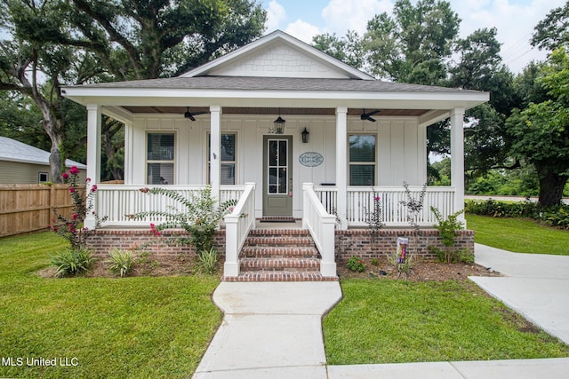 bungalow-style house with ceiling fan, a porch, and a front yard