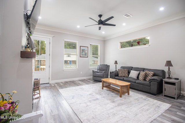 living room featuring hardwood / wood-style flooring, ceiling fan, and ornamental molding