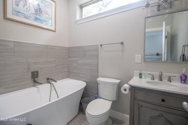 bathroom with vanity, toilet, tile walls, and a bathing tub