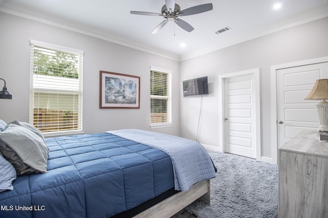 carpeted bedroom featuring ceiling fan, crown molding, and multiple windows