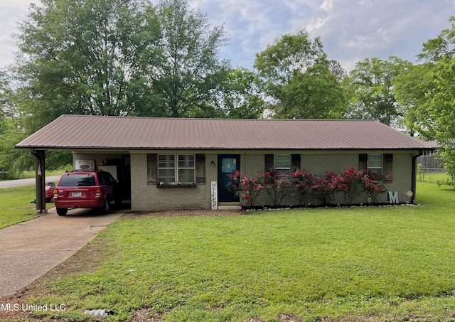 ranch-style home with a front lawn, driveway, metal roof, a carport, and brick siding