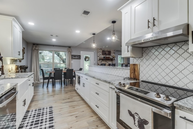 8707 Pine Ridge Ct, Diamondhead, MS 39525 - kitchen featuring appliances with stainless steel finishes, under cabinet range hood, white cabinetry, tasteful backsplash, and light wood-style floors