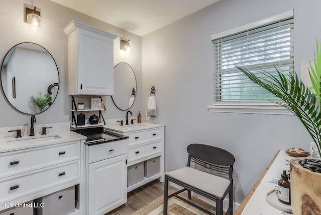 8707 Pine Ridge Ct, Diamondhead, MS 39525 - full bathroom featuring two vanities and wood finished floors
