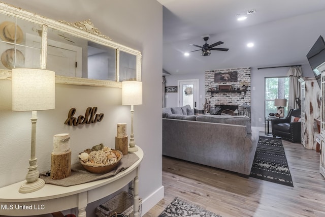 8707 Pine Ridge Ct, Diamondhead, MS 39525 - living room featuring ceiling fan, wood finished floors, a brick fireplace, lofted ceiling, and recessed lighting