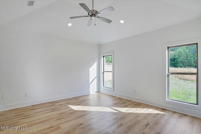 empty room with ceiling fan and light hardwood / wood-style floors