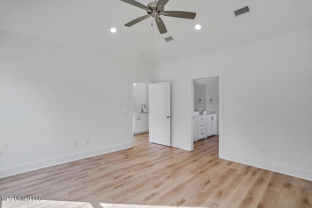 unfurnished bedroom with ceiling fan, light hardwood / wood-style floors, ensuite bathroom, and sink