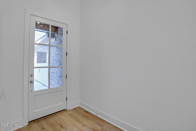 doorway with light wood-type flooring