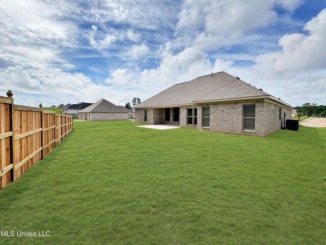 rear view of property with a patio area and a yard