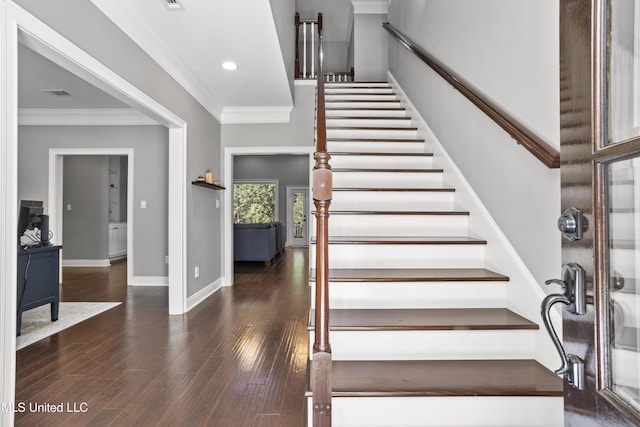 stairway featuring ornamental molding, wood finished floors, visible vents, and baseboards