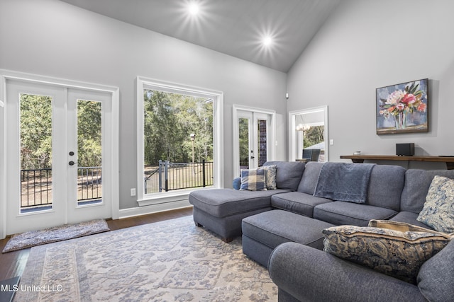 living area with high vaulted ceiling, recessed lighting, french doors, and wood finished floors