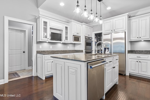 kitchen featuring dark wood-type flooring, a sink, white cabinetry, appliances with stainless steel finishes, and glass insert cabinets