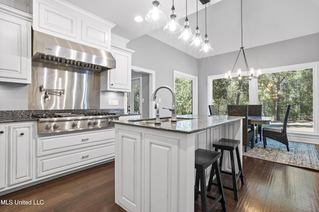 kitchen with stainless steel gas cooktop, dark wood-type flooring, white cabinetry, a sink, and exhaust hood