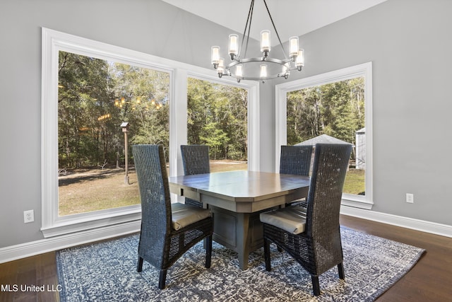 dining room with a chandelier, wood finished floors, and baseboards