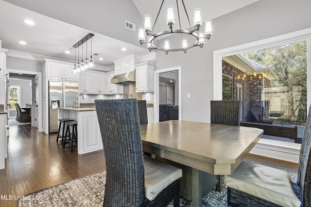 dining space with a chandelier, plenty of natural light, and visible vents