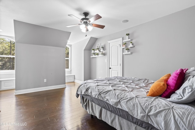 bedroom featuring lofted ceiling, wood-type flooring, baseboards, and a ceiling fan